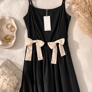 Elegant Black Dress with Cream Bow Accents